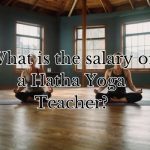 a hatha yoga teacher doing yoga with her student in a studio